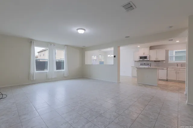 a view of a kitchen with a sink and a refrigerator