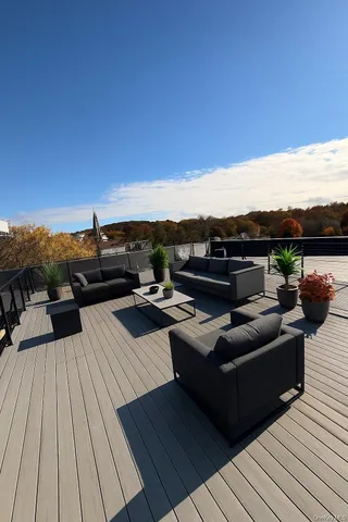 a view of a terrace with couches and sky view