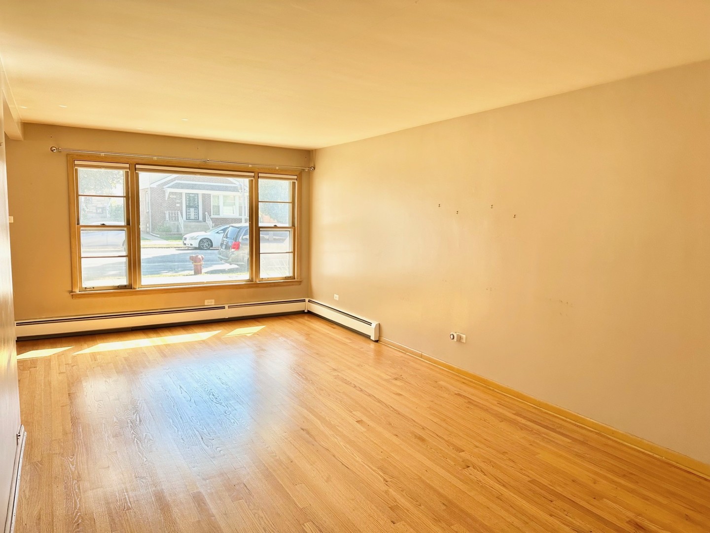 3826 West 83rd Street Chicago, IL 60652 - Photo 2 of 14 an empty room with wooden floor and windows