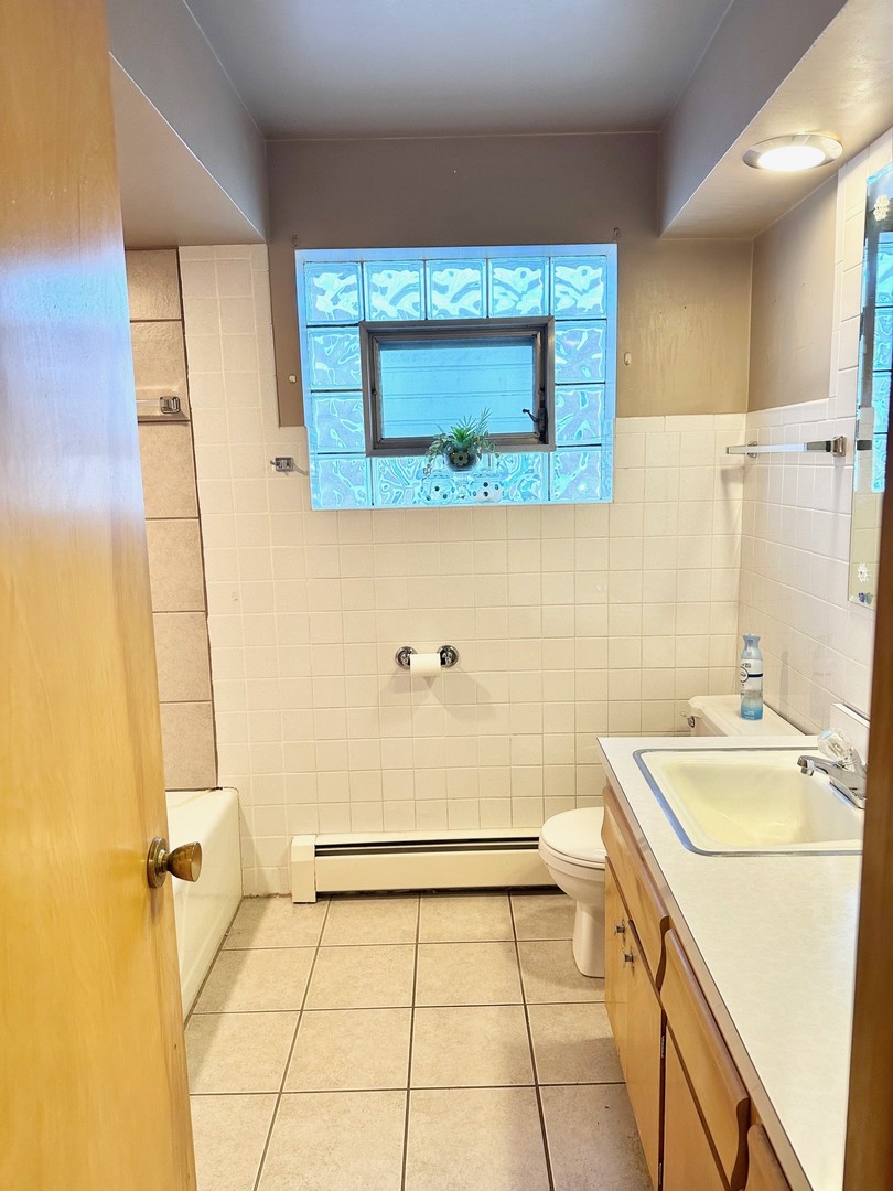3826 West 83rd Street Chicago, IL 60652 - Photo 7 of 14 a bathroom with a sink and a mirror