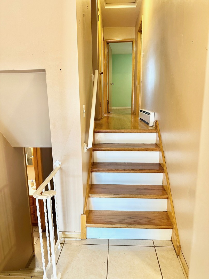 3826 West 83rd Street Chicago, IL 60652 - Photo 8 of 14 a view of staircase with white walls and railing