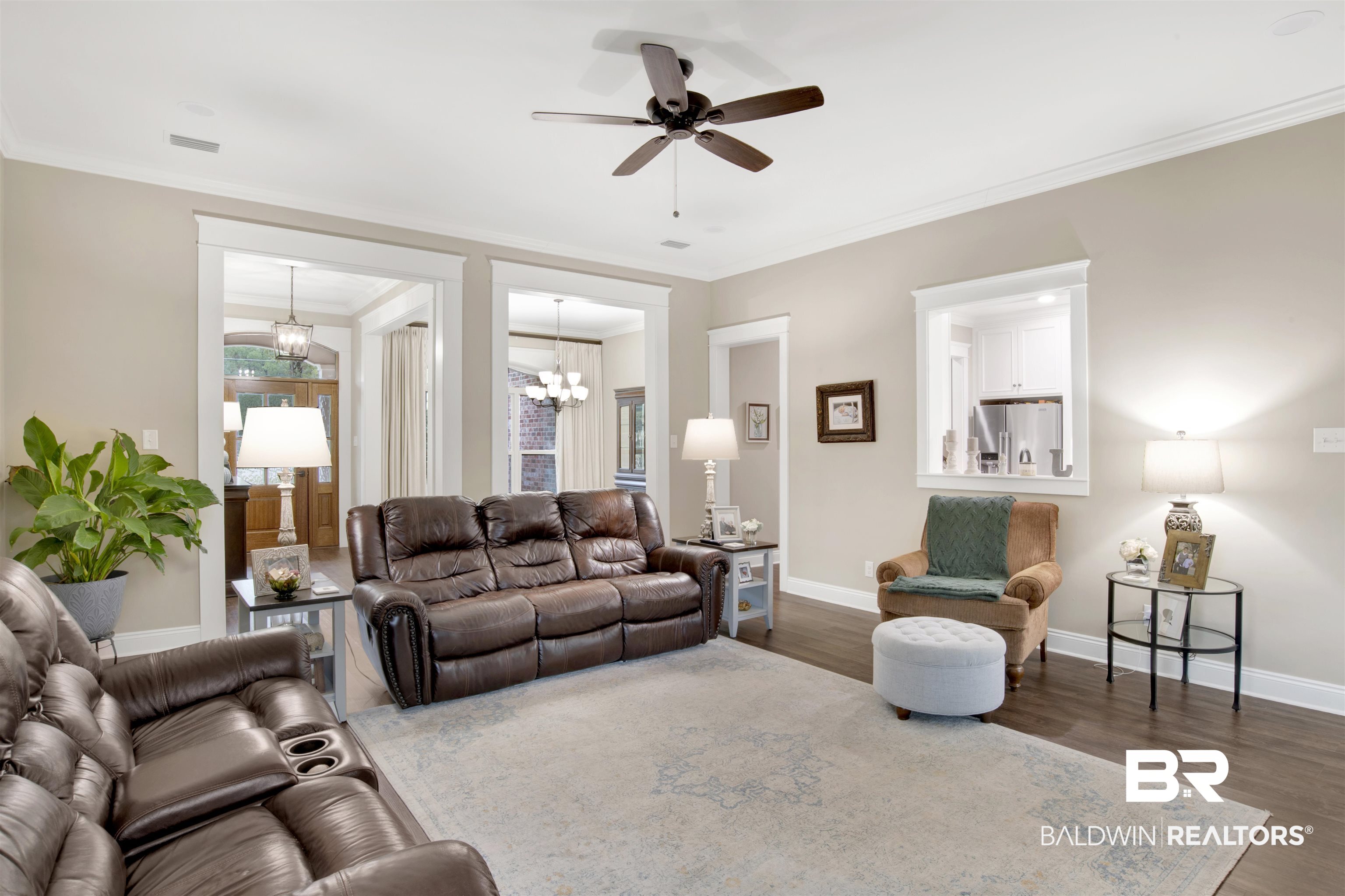 2440 Johnson Road West Mobile, AL 36695 - Photo 27 of 40 Living room featuring dark hardwood / wood-style flooring, ceiling fan with notable chandelier, and ornamental molding