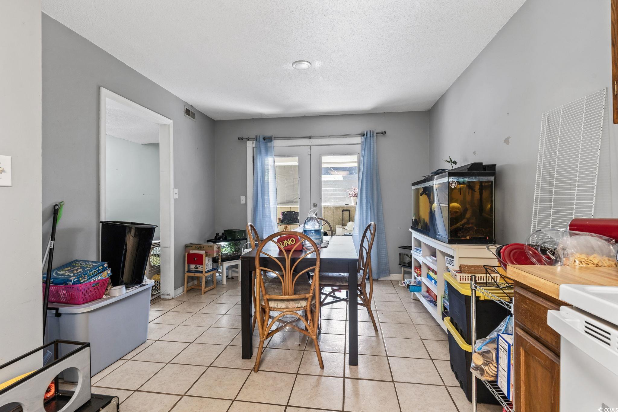 1411 Turkey Ridge Road, Unit 30B Surfside Beach, SC 29575 - Photo 7 of 21 Dining room featuring a textured ceiling, visible vents, and light tile patterned floors