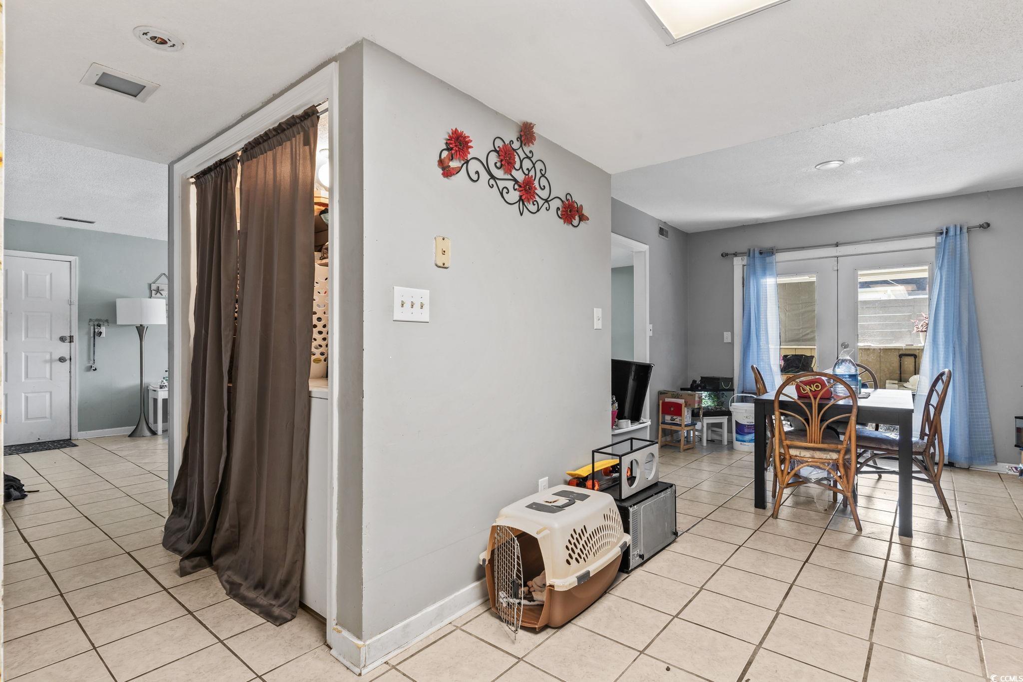 1411 Turkey Ridge Road, Unit 30B Surfside Beach, SC 29575 - Photo 8 of 21 Corridor with visible vents, baseboards, and light tile patterned floors