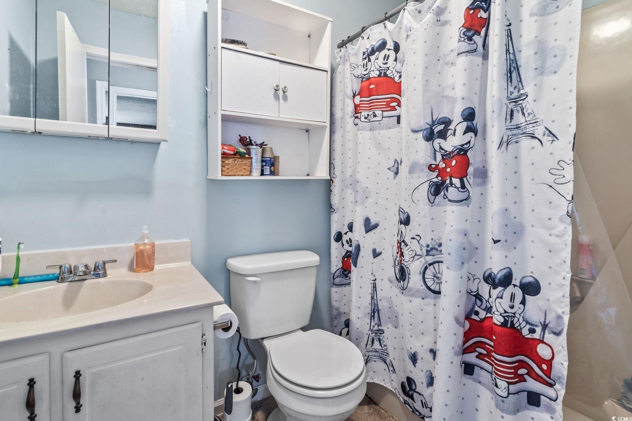 1411 Turkey Ridge Road, Unit 30B Surfside Beach, SC 29575 - Photo 10 of 21 Full bath featuring a shower with curtain, vanity, and toilet