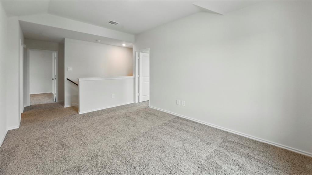 232 Pheasant Run Road Terrell, TX 75160 - Photo 20 of 36 Expansive carpeted room featuring light gray walls, white baseboards, and overhead recessed lighting