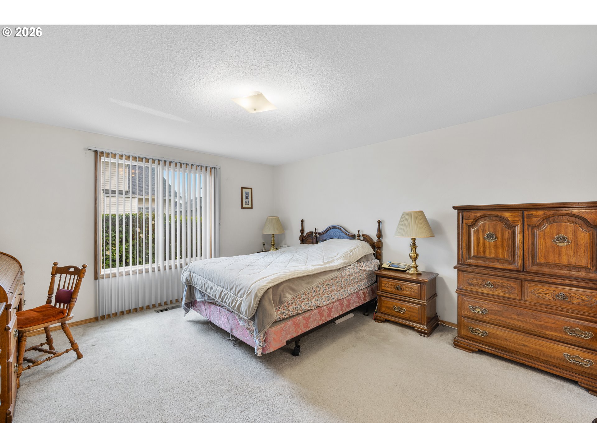 607 Southeast 5th Street Battle Ground, WA 98604 - Photo 16 of 33 a spacious bedroom with a bed chair and window