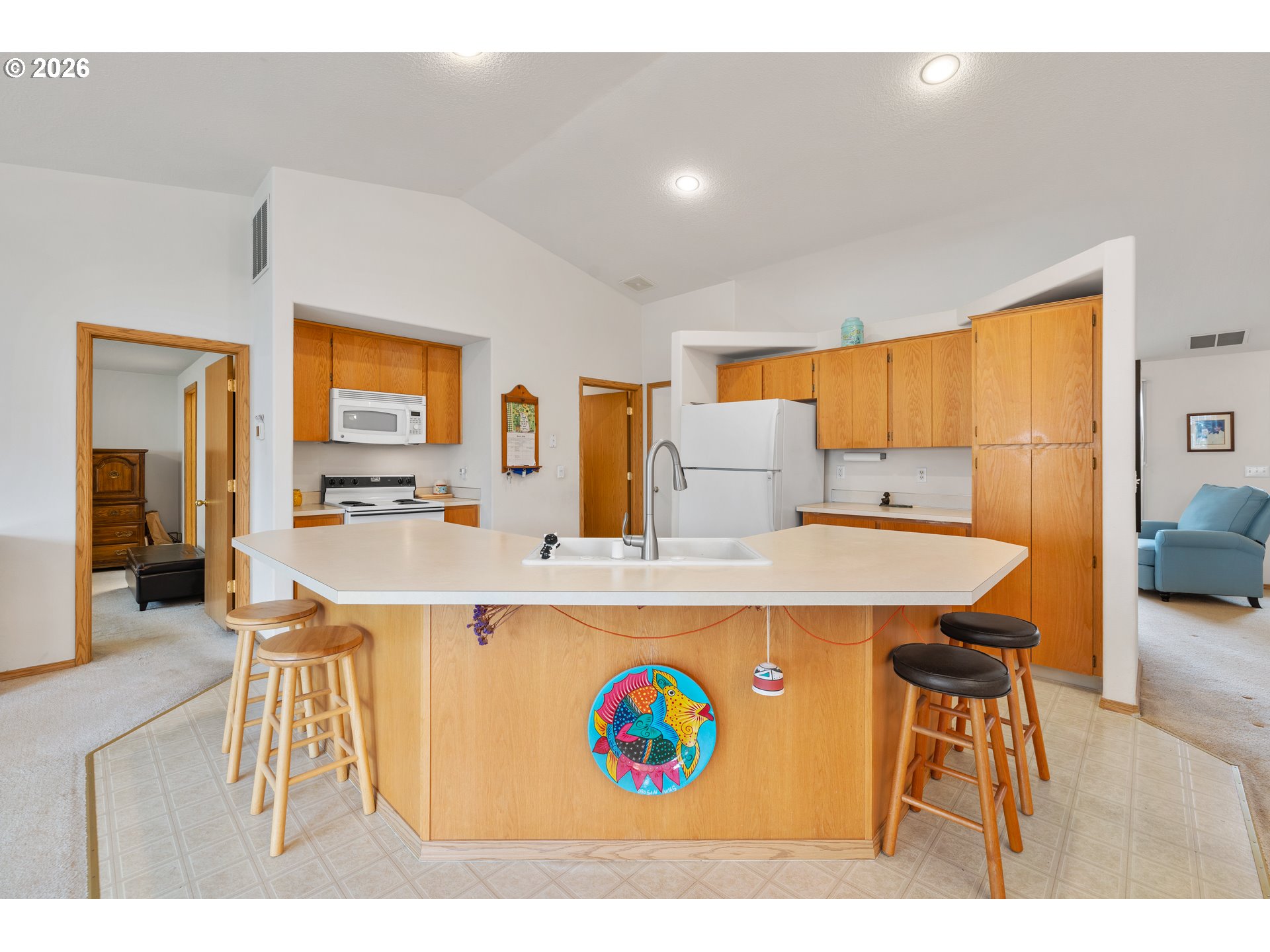 607 Southeast 5th Street Battle Ground, WA 98604 - Photo 25 of 33 a view of kitchen island with stainless steel appliances granite countertop dining table chairs sink and wooden floor