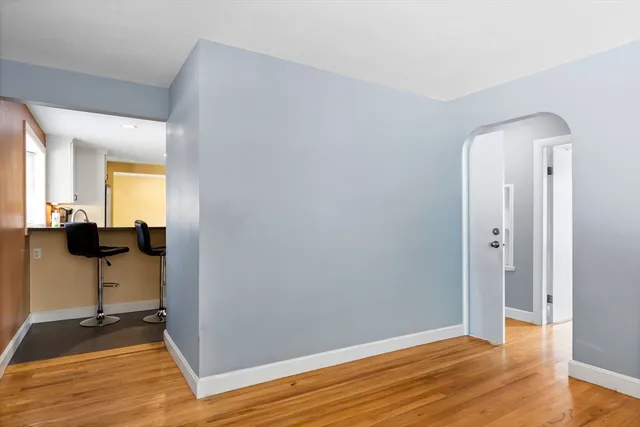 a view of a room with wooden floor and furniture