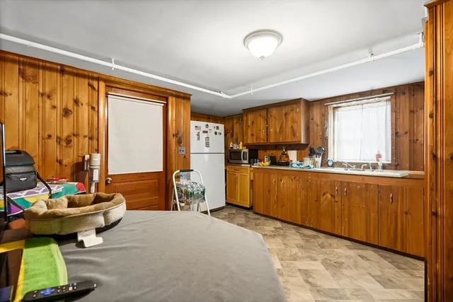 a kitchen with sink refrigerator and large window