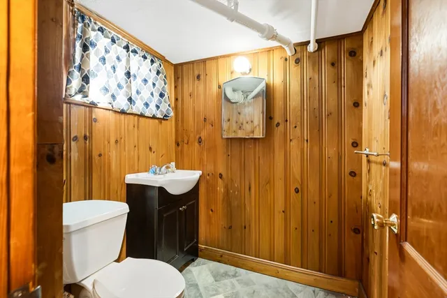 a bathroom with a sink mirror vanity and toilet