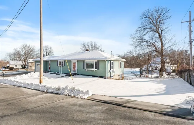 a white house with a large tree in front of it