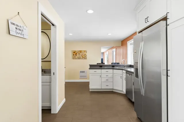 a kitchen with cabinets and a refrigerator