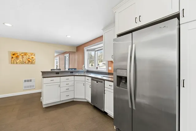 a kitchen with stainless steel appliances a refrigerator sink and cabinets