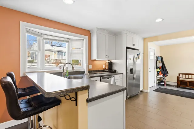a kitchen with refrigerator cabinets and sink
