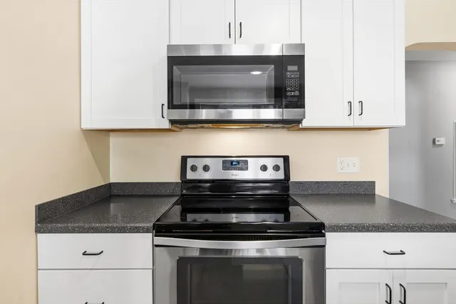a stove top oven sitting inside of a kitchen