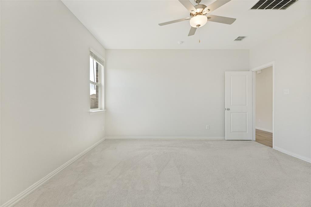 1237 Almond Road Azle, TX 76020 - Photo 10 of 24 an empty room with fan and windows