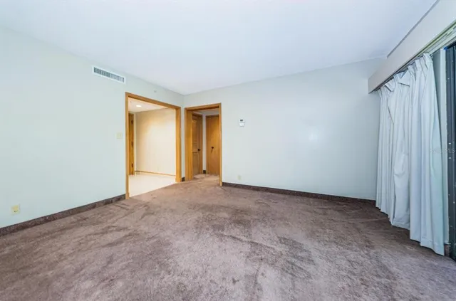 a view of an empty room and wooden door