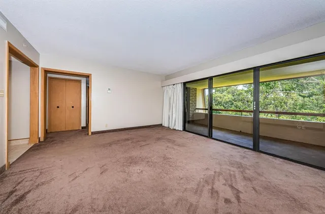 a view of an empty room with a large window