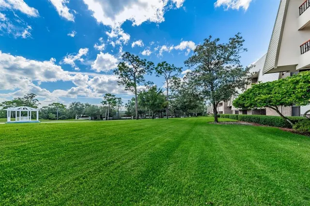 a view of a house with a backyard