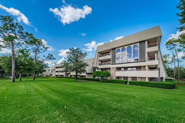 a front view of a house with a yard and potted plants
