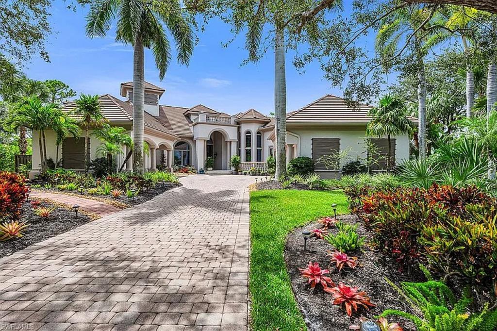 1237 Pocantico Lane Naples, FL 34110 - Photo 1 of 20 a front view of a house with a garden