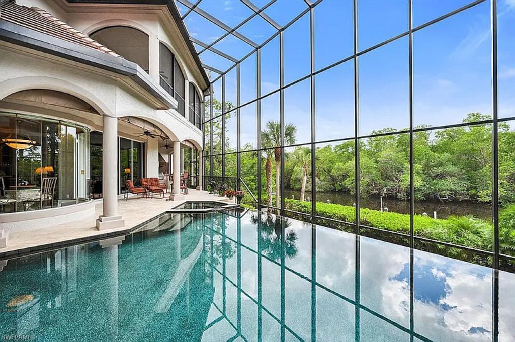 1237 Pocantico Lane Naples, FL 34110 - Photo 11 of 20 a view of a house with a swimming pool