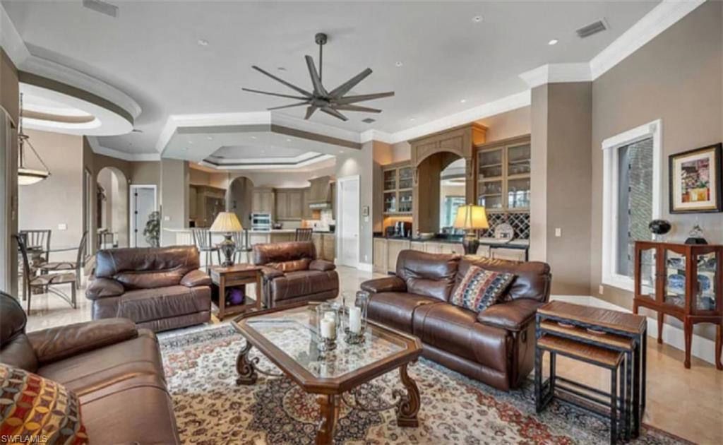 1237 Pocantico Lane Naples, FL 34110 - Photo 13 of 20 a living room with furniture ceiling fan and a rug