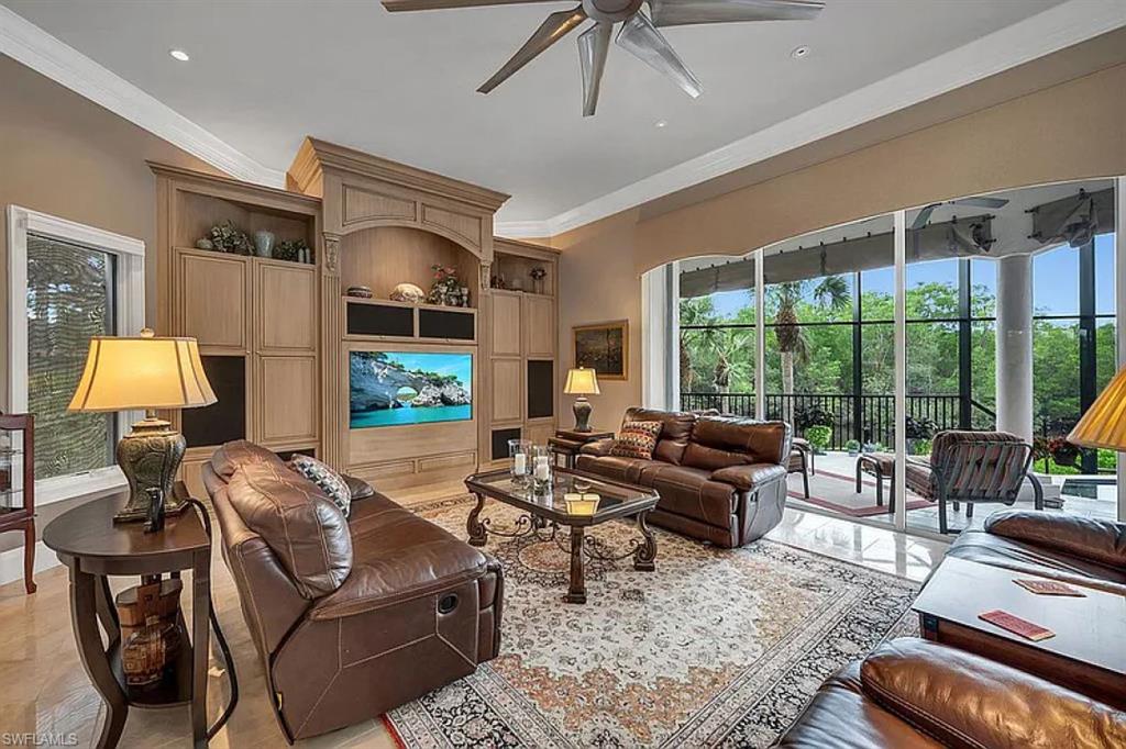 1237 Pocantico Lane Naples, FL 34110 - Photo 14 of 20 a living room with furniture and a flat screen tv