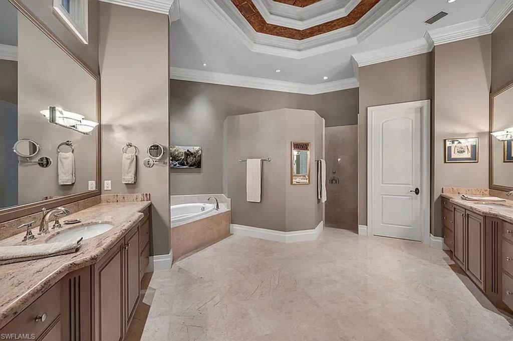 1237 Pocantico Lane Naples, FL 34110 - Photo 17 of 20 a large bathroom with a granite countertop double vanity sink a mirror and a bathtub