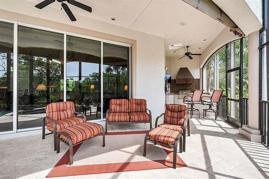 1237 Pocantico Lane Naples, FL 34110 - Photo 18 of 20 a living room with furniture and a floor to ceiling window