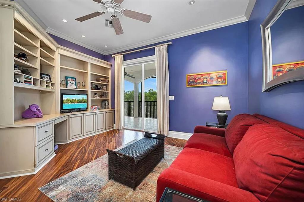 1237 Pocantico Lane Naples, FL 34110 - Photo 5 of 20 a living room with furniture and a book shelf
