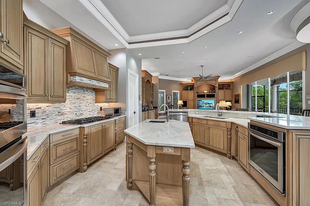 1237 Pocantico Lane Naples, FL 34110 - Photo 8 of 20 a kitchen with stainless steel appliances granite countertop a sink stove and cabinets