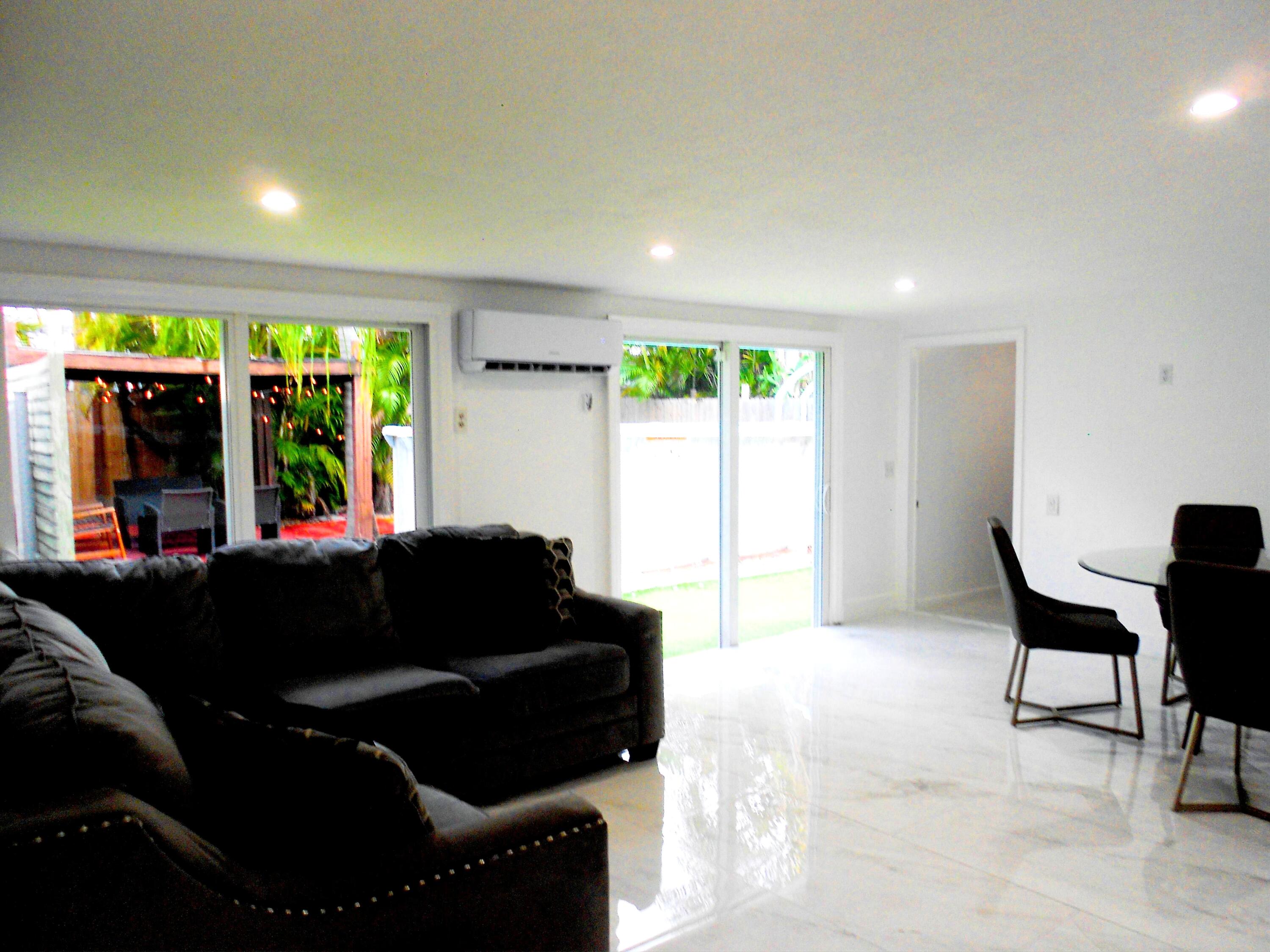 817 Northwest 30th Court Wilton Manors, FL 33311 - Photo 4 of 17 a living room with furniture and a large window