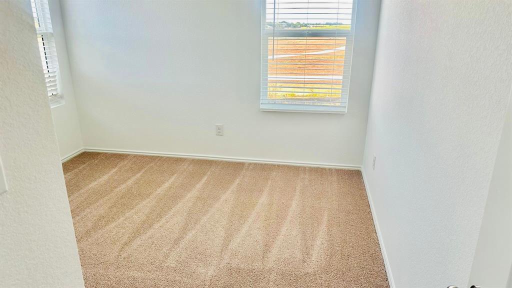 192 Rodney Boat Road Kyle, TX 78640 - Photo 33 of 38 A well-lit room awaits your personal touch with new, clean carpeting and window blinds.