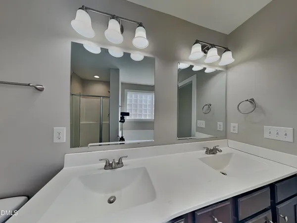a bathroom with a sink a mirror and a vanity