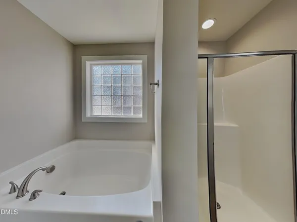 a white bath tub sitting next to a window