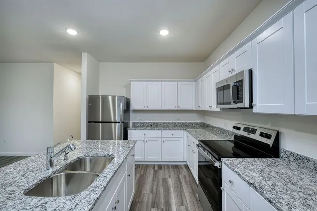 a kitchen with a sink stove and refrigerator