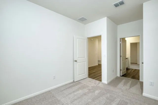 an empty room and a bathroom