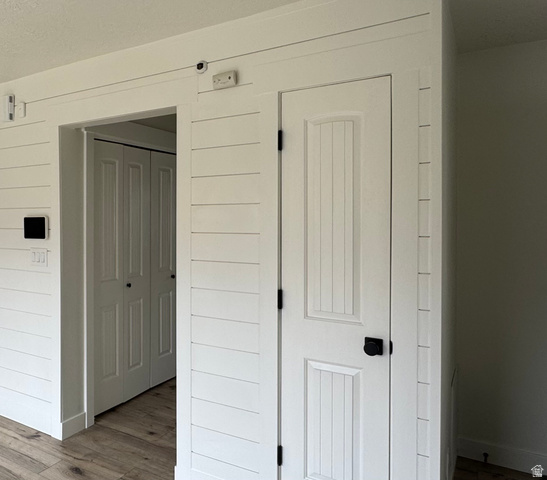 608 South 500 West, Unit 3 Provo, UT 84601 - Photo 17 of 35 Shiplap accent wall featuring a panel door with matte black hardware and wood-finish flooring
