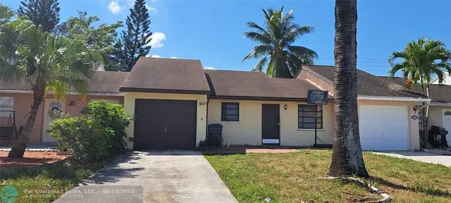 a house that has a tree in front of it