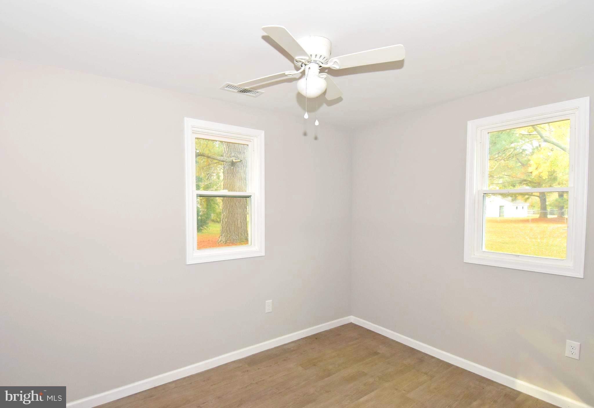 4078 Jacksonville Road Crisfield, MD 21817 - Photo 14 of 43 an empty room with a window and a fan