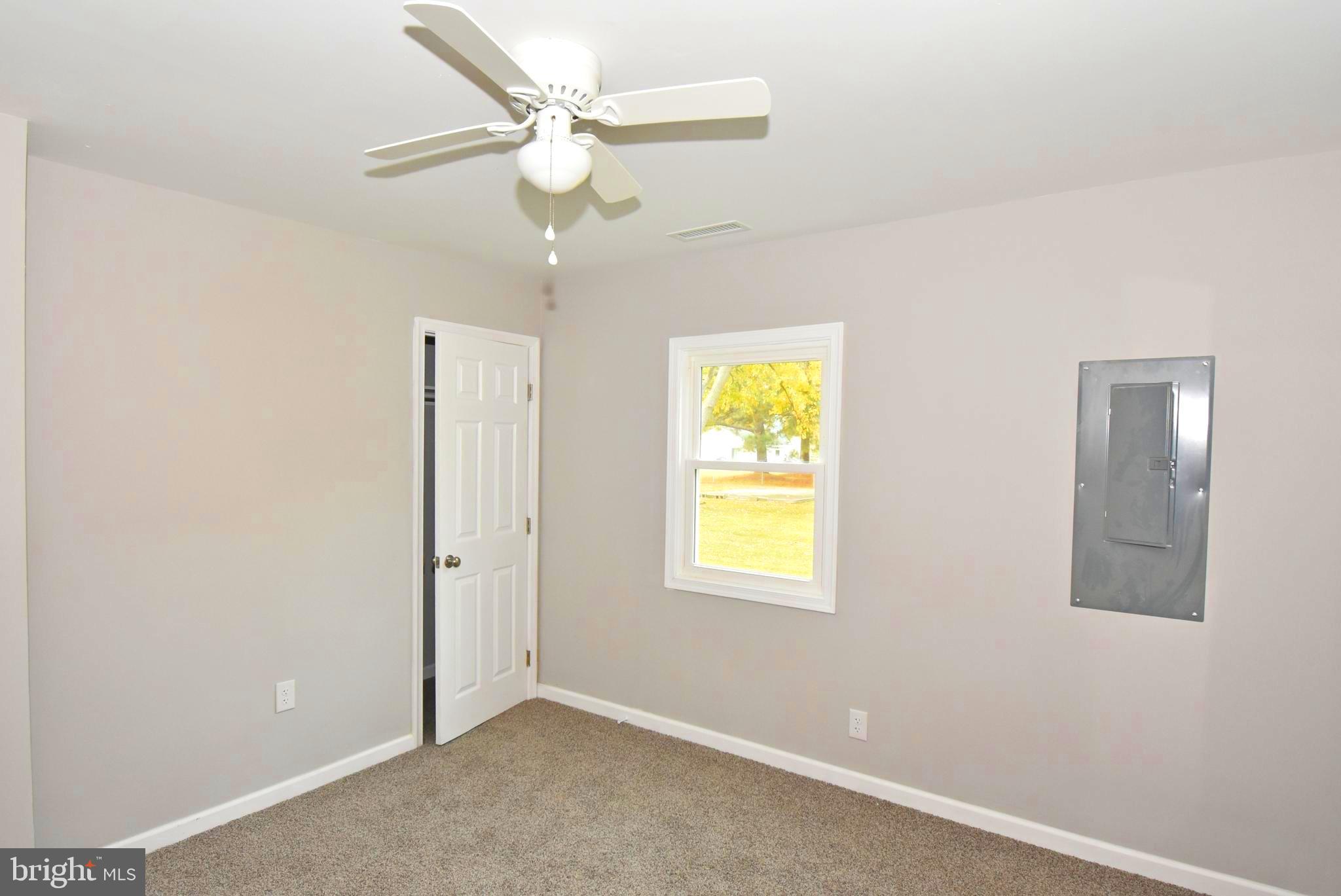 4078 Jacksonville Road Crisfield, MD 21817 - Photo 20 of 43 an empty room with a window and ceiling fan