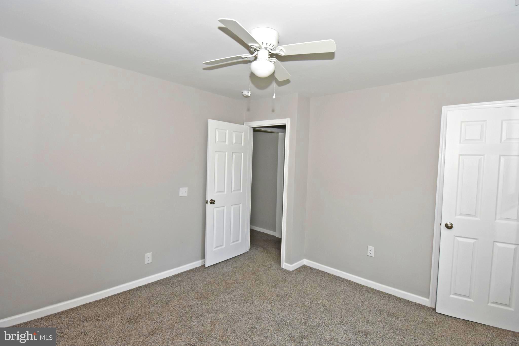 4078 Jacksonville Road Crisfield, MD 21817 - Photo 21 of 43 an empty room with a ceiling fan and a window