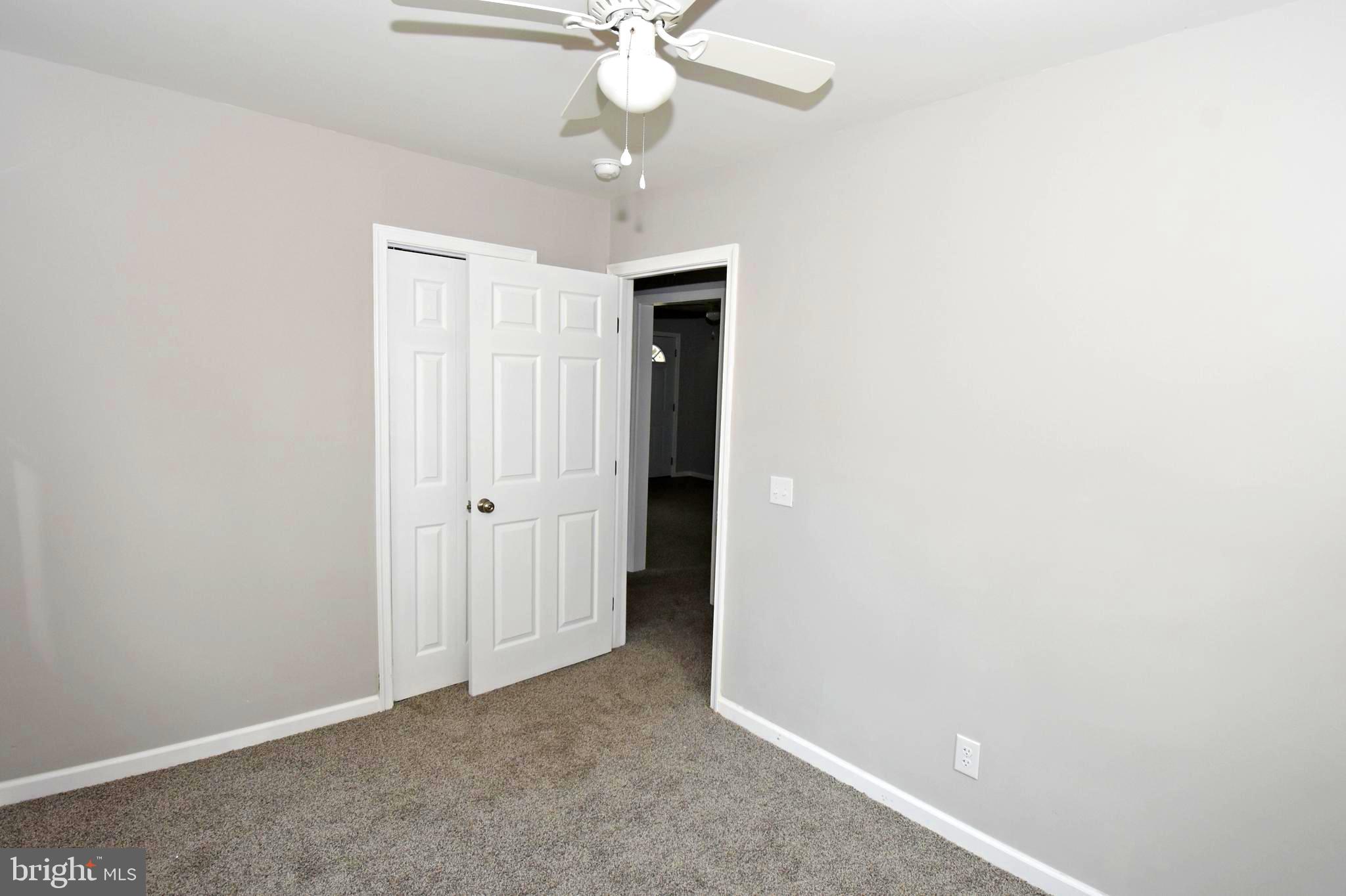 4078 Jacksonville Road Crisfield, MD 21817 - Photo 25 of 43 an empty room with a chandelier fan and closet area