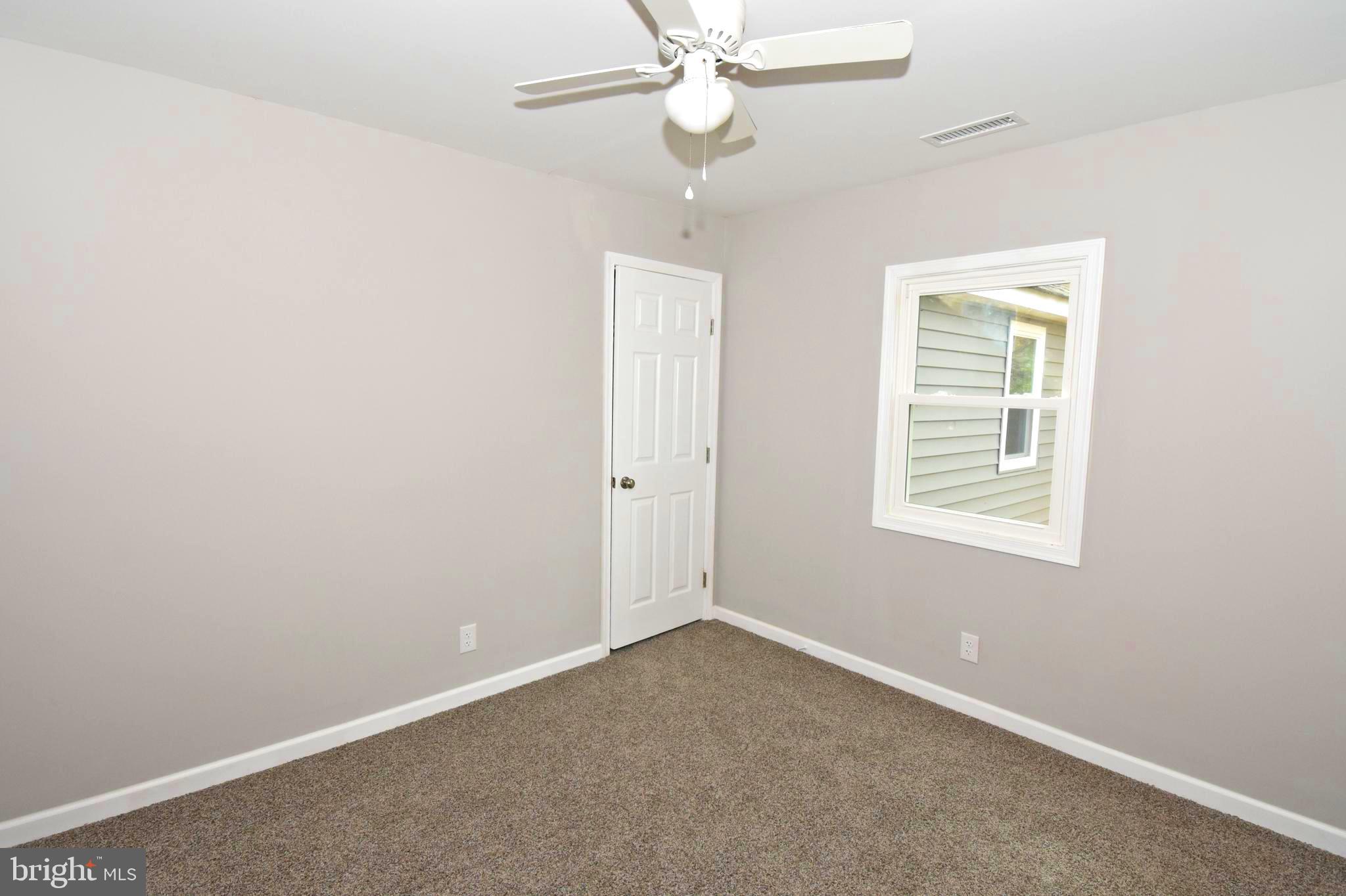 4078 Jacksonville Road Crisfield, MD 21817 - Photo 27 of 43 an empty room with a window and a fan