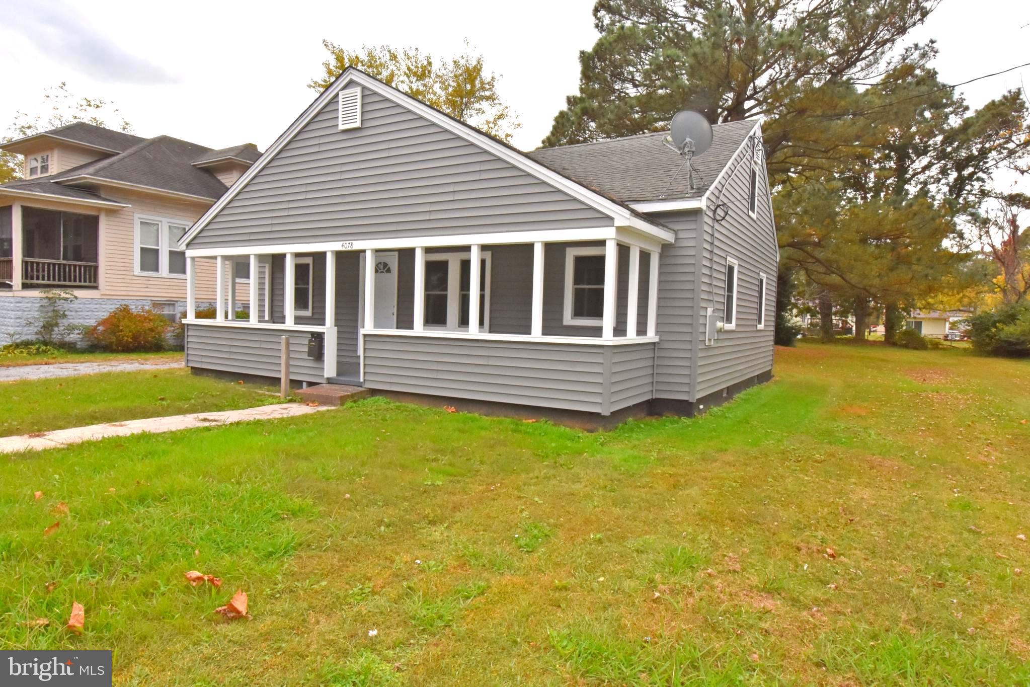4078 Jacksonville Road Crisfield, MD 21817 - Photo 36 of 43 a front view of a house with a garden and yard