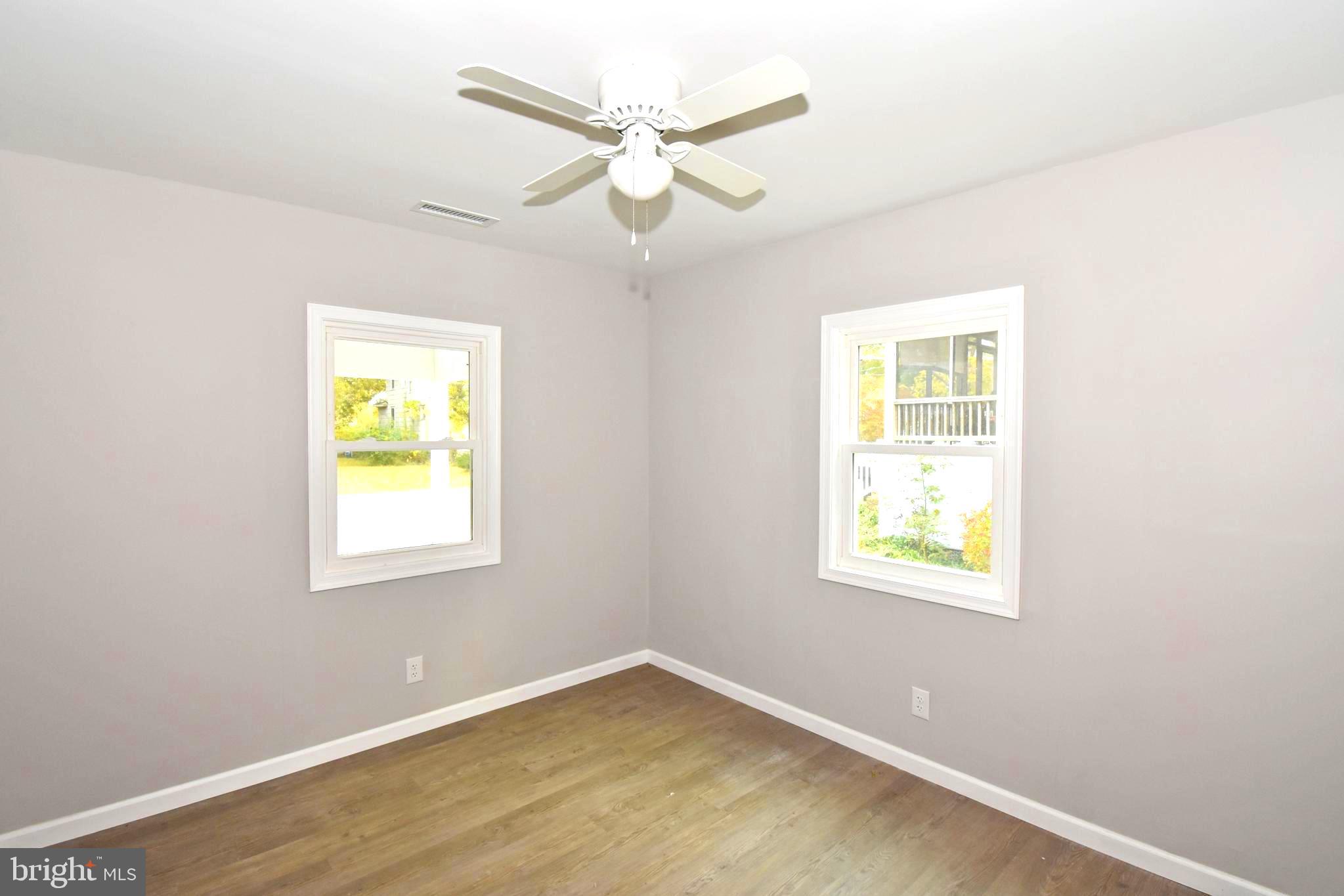 4078 Jacksonville Road Crisfield, MD 21817 - Photo 8 of 43 an empty room with a window and a ceiling fan