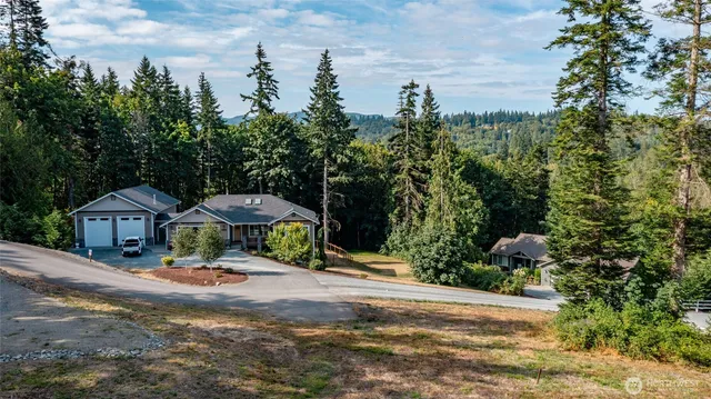 a view of a house with yard and sitting area