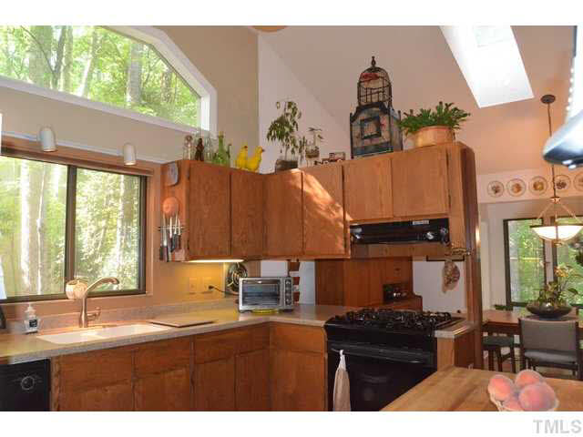 245 Fox Ridge Pittsboro, NC 27312 - Photo 4 of 25 WOW -- what a great kitchen! Corian counters, gas stove, wood flooring, cathedral ceiling, and a walk-in pantry closet!
